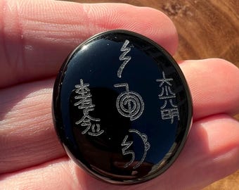 Master Reiki Symbols engraved on a Black Obsidian Palm.
