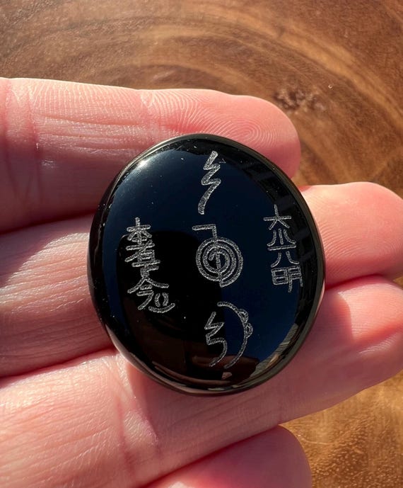 Master Reiki Symbols engraved on a Black Obsidian Palm.