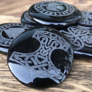 Thor&#39;s Hammer Strength and Protection Viking symbol engraved on a Black Obsidian Palm.
