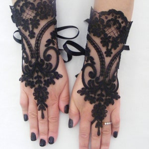 May include: A pair of black lace fingerless gloves with ribbon ties at the wrist.