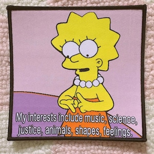 May include: Square patch featuring a cartoon character with yellow hair and a white pearl necklace. The patch has the text "My interests include music, science, justice, animals, shapes, feelings." The background is pink and purple.