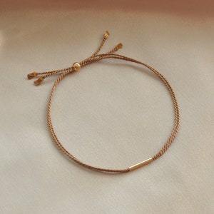 Silk Double Strand Gold Filled Bar bracelet. 14kt gold filled hardware throughout. Glass bottle presentation. Jewelry gifts for her him them