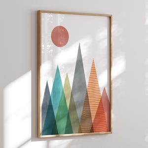 May include: Abstract geometric mountain landscape print with a red sun in the sky. The mountains are in shades of blue, green, yellow, orange, and red.