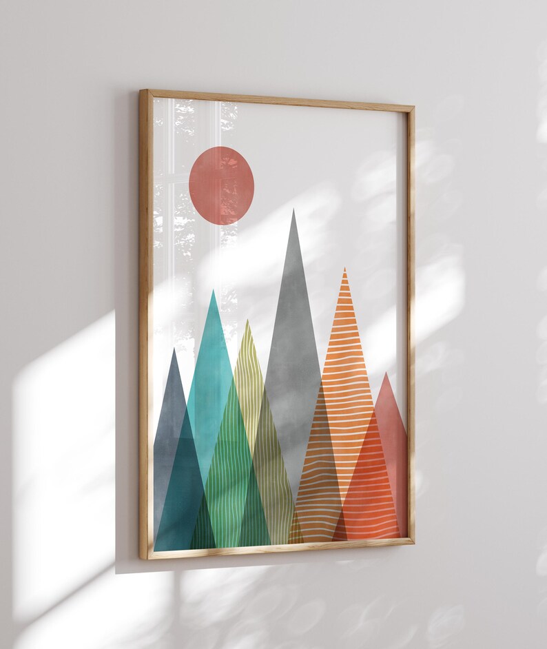 May include: Abstract geometric mountain landscape print with a red sun in the sky. The mountains are in shades of blue, green, yellow, orange, and red.