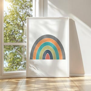 May include: A framed print of a colourful rainbow with a grey background. The rainbow is made up of orange, teal, yellow, and blue stripes.