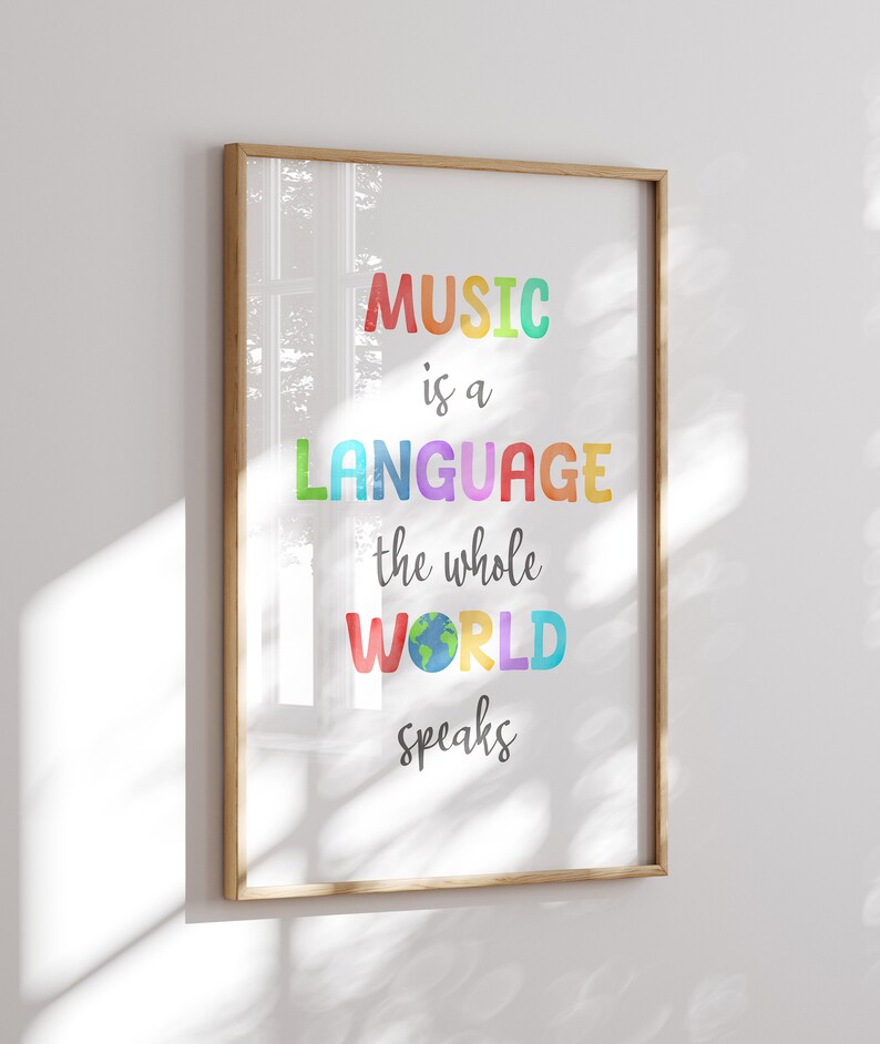 May include: A framed print with the text "MUSIC is a LANGUAGE the whole WORLD speaks" in colorful letters. The word "WORLD" has a small image of a globe inside the letter "O".