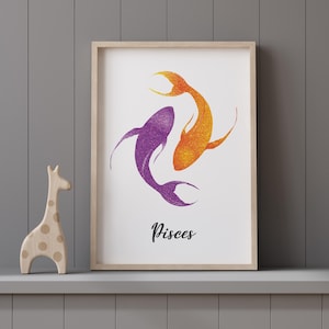May include: Framed art print featuring two stylized fish in shades of purple and orange, representing the Pisces zodiac sign. The artwork has a glittery texture and is displayed on a gray shelf with a wooden giraffe figurine.