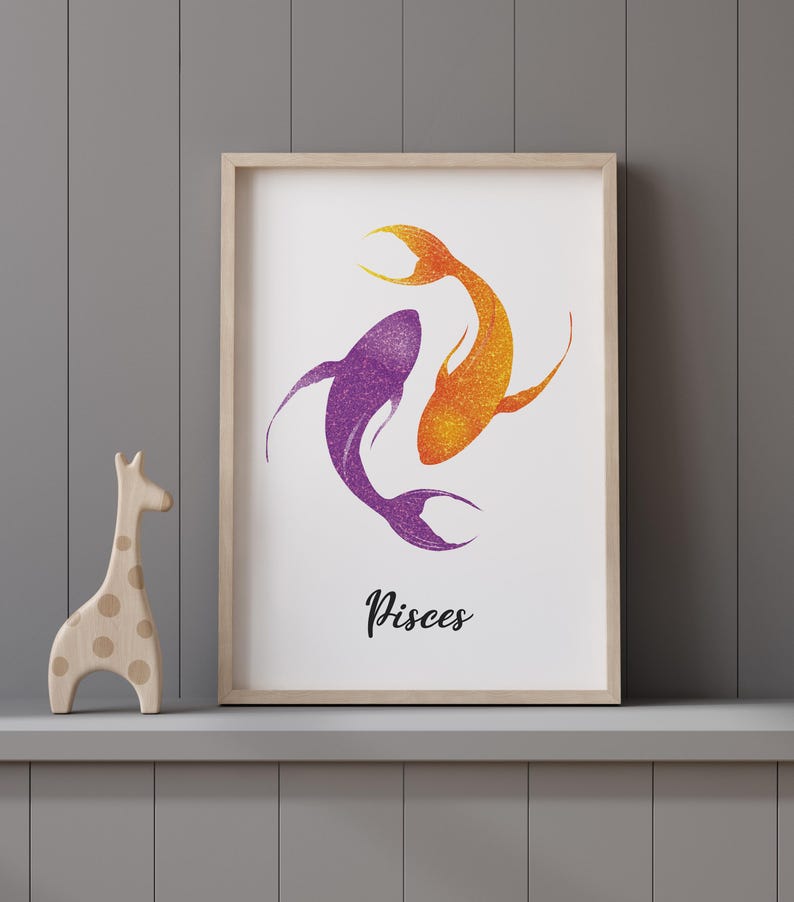 May include: Framed art print featuring two stylized fish in shades of purple and orange, representing the Pisces zodiac sign. The artwork has a glittery texture and is displayed on a gray shelf with a wooden giraffe figurine.