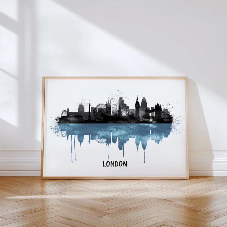 May include: A framed print featuring a black and blue watercolor depiction of the London skyline. The artwork includes iconic landmarks like Big Ben and the London Eye, with the word "LONDON" printed below.