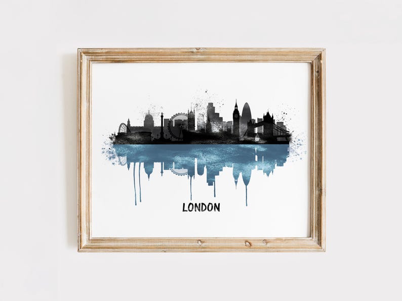 May include: Framed art print featuring a black and blue watercolor depiction of the London skyline. The image includes iconic landmarks and a reflective water effect, with the city name printed below.