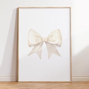 May include: A watercolour painting of a large, white bow with a subtle beige tint. The bow is centred on a white background and is framed in a light wood frame.