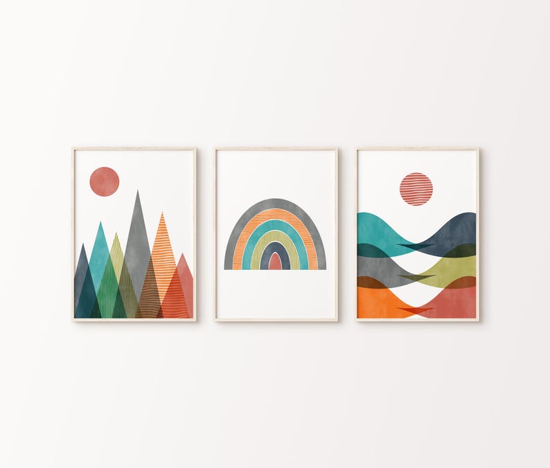 May include: Set of three abstract art prints featuring geometric shapes in shades of blue, green, orange, and red. The prints depict a mountain range, a rainbow arch, and a series of wavy lines.