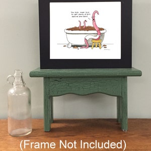 May include: A framed cartoon illustration of worms in a bathtub with the caption "You kids make sure to get plenty of dirt behind your ears!" The frame is black and the illustration is on white paper.