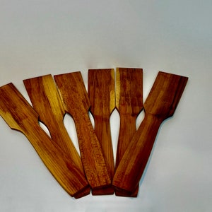 Image of six handmade maple woodcooking spatulas with varying woodgrain.