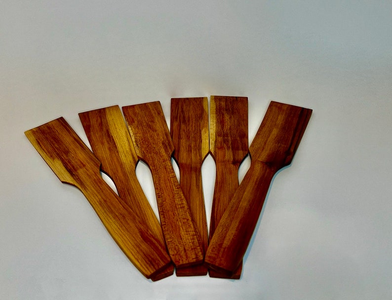 Image of six handmade maple woodcooking spatulas with varying woodgrain.