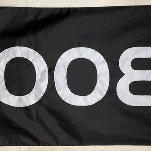 May include: A black flag with the word "BOO" written in white letters.