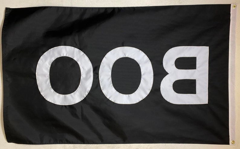 May include: A black flag with the word "BOO" written in white letters.
