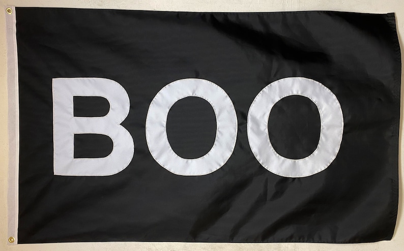 May include: A black flag with the word "BOO" written in white letters.
