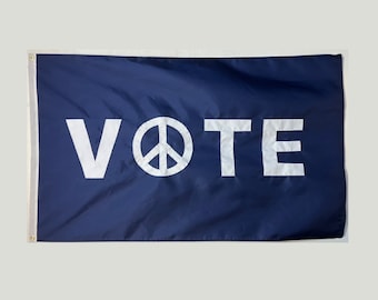May include: A navy blue flag with the word "VOTE" in white letters and a white peace symbol in between the "O" and the "T".