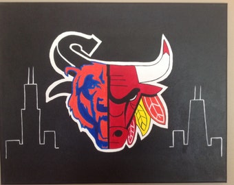 May include: A black canvas painting with a white outline of the Chicago skyline. The center of the painting features a red and black bull head with yellow feathers and a blue and orange bear head.