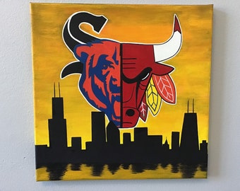 May include: A painting of the Chicago Bulls and Chicago Bears logos, with the Chicago skyline in the background. The logos are painted in red, blue, and black, and the skyline is painted in black. The background is a yellow sunset.