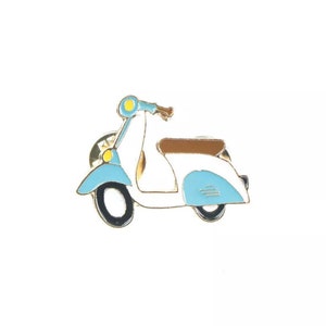 May include: A blue and white scooter pin with a brown seat. The scooter is made of metal and has a gold finish.