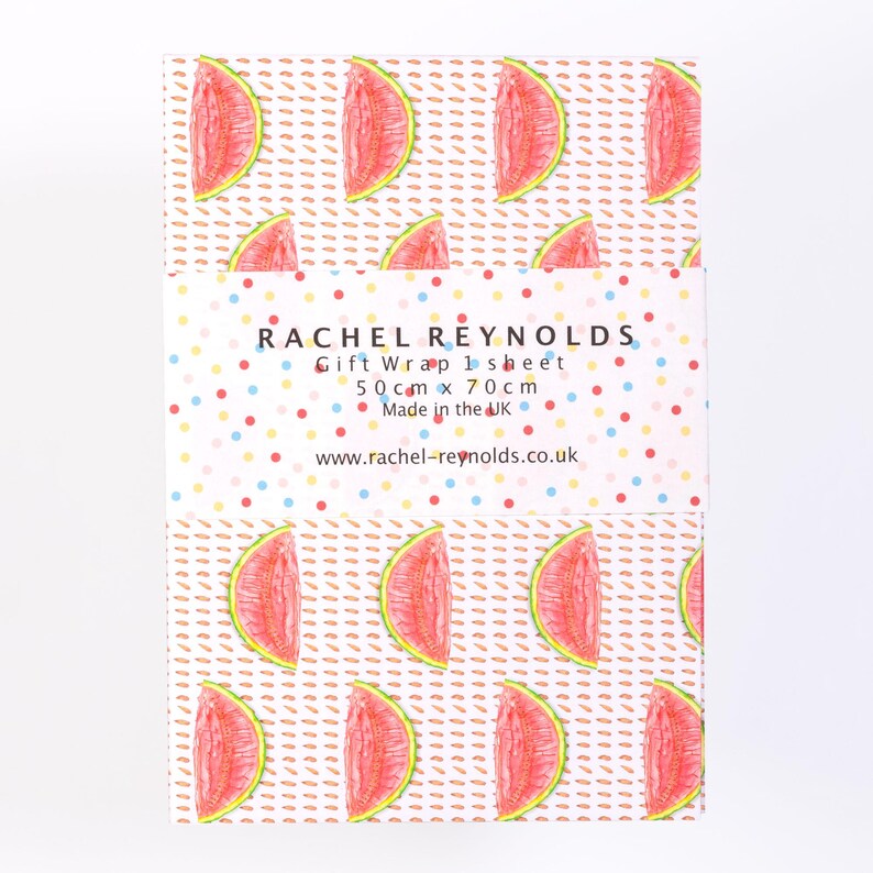 May include: A sheet of gift wrap featuring a repeating pattern of watermelon slices on a dotted background. The gift wrap is labeled "RACHEL REYNOLDS Gift Wrap 1 sheet" and measures 19.6 inches x 27.5 inches. The gift wrap is made in the UK.