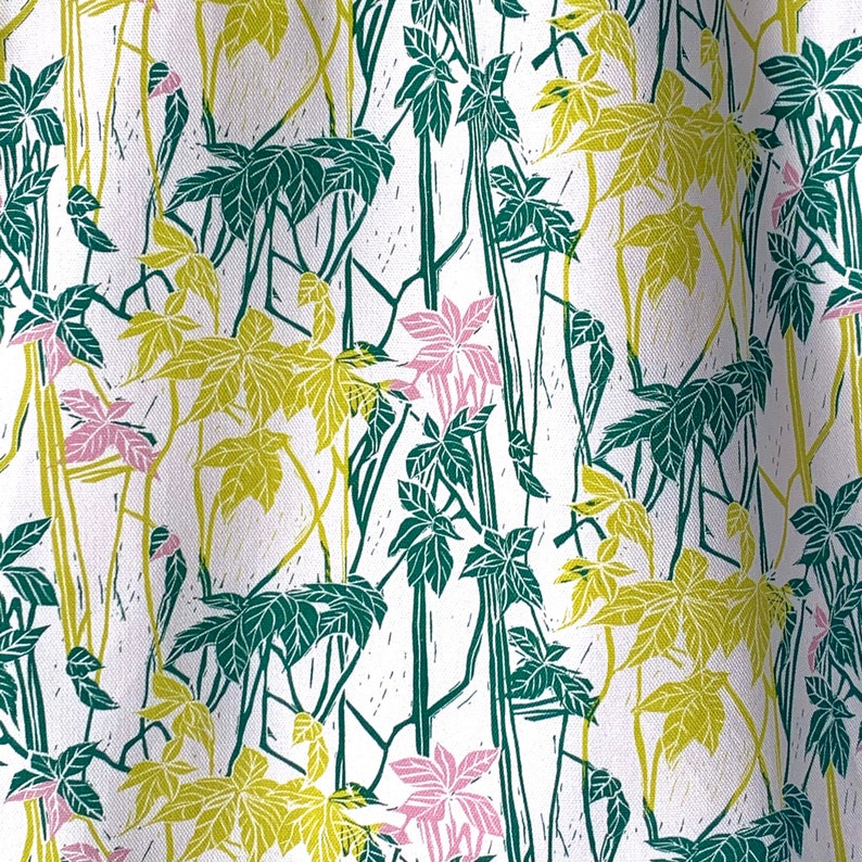 May include: A white fabric with a repeating pattern of green and yellow leaves and pink flowers. The pattern is stylized and resembles a woodblock print.