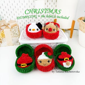 May include: Five small crocheted plush dumplings in open containers. Two red containers hold a white snowman and a brown reindeer. Three green containers hold a red Santa suit, a gingerbread person with a green hat, and a red Santa suit.