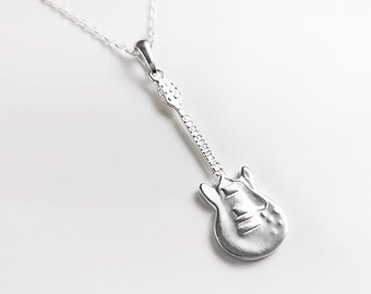 May include: A silver guitar pendant necklace. The guitar is detailed with a textured finish and a chain.