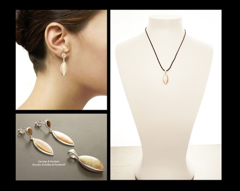 May include: A jewelry set consisting of two drop earrings and a pendant, each featuring a marquise-shaped, iridescent stone set in silver-toned metal. The pendant hangs from a thin black cord, and the earrings have a post-back closure mechanism.