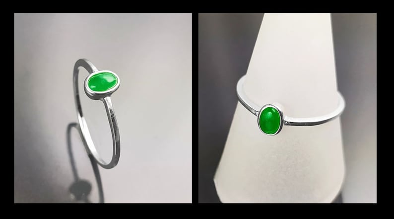 May include: A silver ring with a bright green oval gemstone.