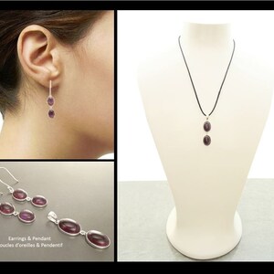 May include: Silver earrings and pendant necklace featuring oval, deep purple gemstones. The jewelry is displayed on a mannequin and a person's ear. The image also shows a close-up of the earrings and pendant.