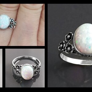 Puede incluir: Anillo de plata con una piedra de &oacute;palo ovalada e iridiscente. El anillo presenta detalles florales alrededor de la piedra y en la banda. El &oacute;palo muestra destellos de color. El dise&ntilde;o del anillo sugiere un estilo vintage.