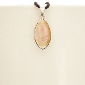 May include: A marquise-shaped pendant featuring an iridescent, pale pink and cream-colored shell inlay set within a polished silver-toned metal frame. The pendant is suspended from a dark brown cord, showcasing a smooth, reflective surface.