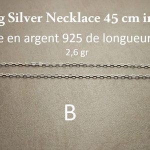 May include: A sterling silver necklace, 45 cm in length, displayed on a gray surface. The necklace is made of small, linked silver pieces. Text on the image reads "Sterling Silver Necklace 45 cm in length" and "2,6 gr".