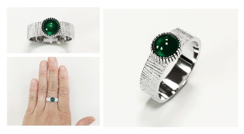 Puede incluir: Un anillo de plata con una banda texturizada y una piedra preciosa redonda verde.