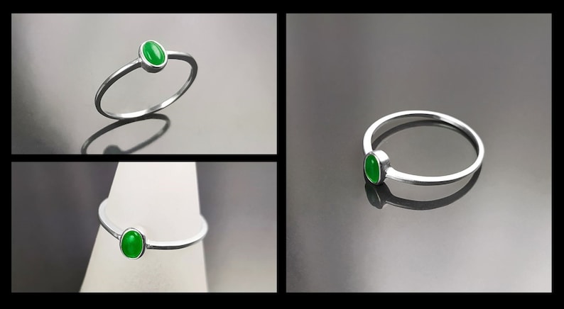 May include: A silver ring with a green oval-shaped gemstone.