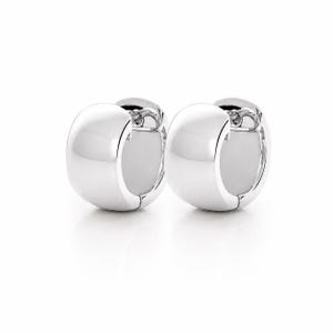 May include: A pair of polished silver-tone hoop earrings with a thick, rounded profile. These earrings feature a smooth, reflective surface and a hinged closure mechanism, showcasing a clean, circular design that sits side by side in the frame.