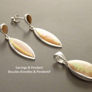 May include: A pair of silver drop earrings and a matching pendant, each featuring a marquise-shaped iridescent stone. The earrings have a small teardrop-shaped accent at the top. The text "Earrings & Pendant" is visible in the image.
