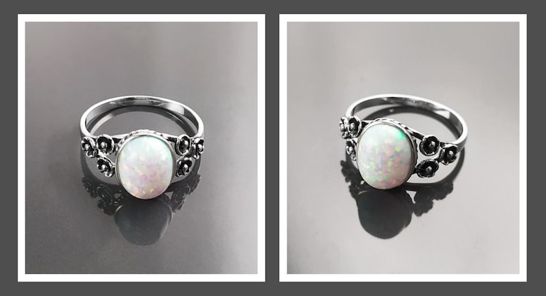 Puede incluir: Un anillo de plata con una piedra de &oacute;palo ovalada e iridiscente. El anillo presenta un dise&ntilde;o floral a cada lado del &oacute;palo. El &oacute;palo es de color blanco nacarado con toques rosados y verdes. El anillo se muestra sobre una superficie reflectante.