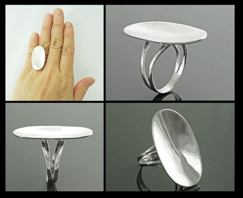 K&ouml;nnte beinhalten: Ein silberner Ring mit einer gro&szlig;en ovalen Oberseite. Der Ring ist mit einem doppelten Band gestaltet, das sich um den Finger wickelt.