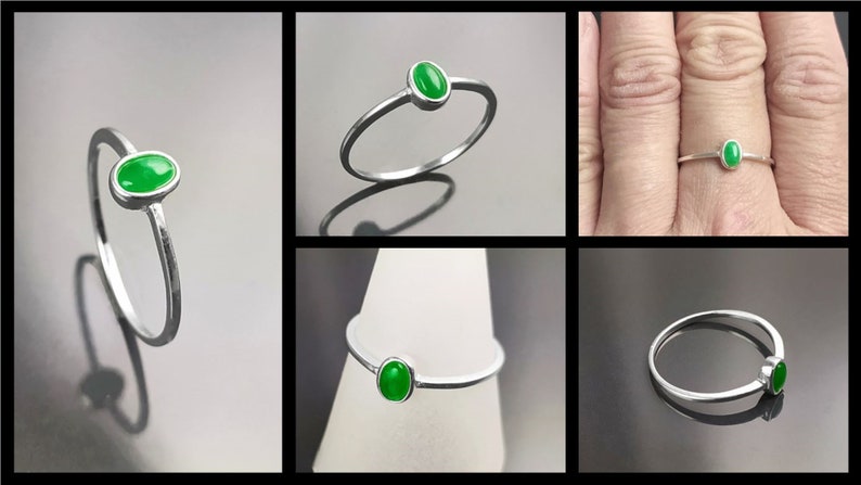 May include: A silver ring with a green oval gemstone. The ring is simple and delicate, and the gemstone is set in a bezel setting.