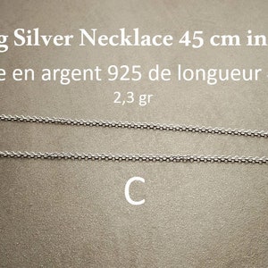 May include: A silver chain necklace, 45 inches long, made of 925 sterling silver. The necklace weighs 2.3 grams. The text "Sterling Silver Necklace 45 cm in length" and "Cha&icirc;ne en argent 925 de longueur 45 cm" is visible in the image.