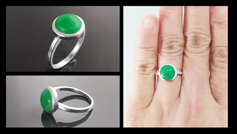 May include: A silver ring featuring a round, bright green gemstone. The gemstone is set in a bezel setting, and the ring has a simple, elegant band. The ring is shown in multiple views, including a close-up and on a finger.