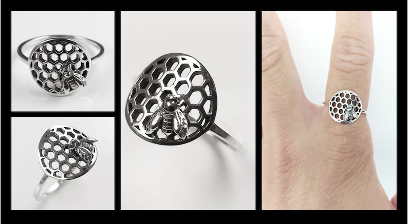 Op de afbeelding: Een zilveren ring met een bij- en honingraatontwerp. De ring is gemaakt van metaal en heeft een ronde vorm. De bij bevindt zich in het midden van het honingraatontwerp.