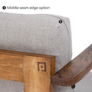 May include: A light gray upholstered chair cushion with a middle seam edge option, featuring a wooden frame with a visible logo that reads PUNKT. The wood has a natural grain, and the cushion is textured with a woven fabric appearance.