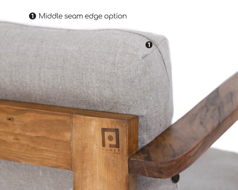 May include: A light gray upholstered chair cushion with a middle seam edge option, featuring a wooden frame with a visible logo that reads PUNKT. The wood has a natural grain, and the cushion is textured with a woven fabric appearance.