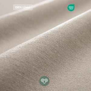 May include: A close-up view of beige linen fabric with a visible woven texture. The image includes a label stating 100% Linen, a green circular OEKO-TEX certification badge, and a small green circular icon featuring a stylized ram head symbol.