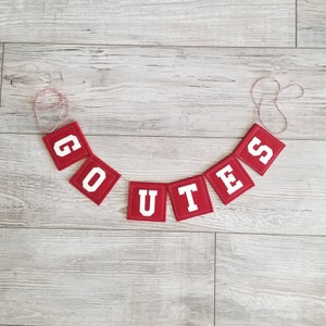 May include: Red felt banner with white letters spelling "GO UTES".